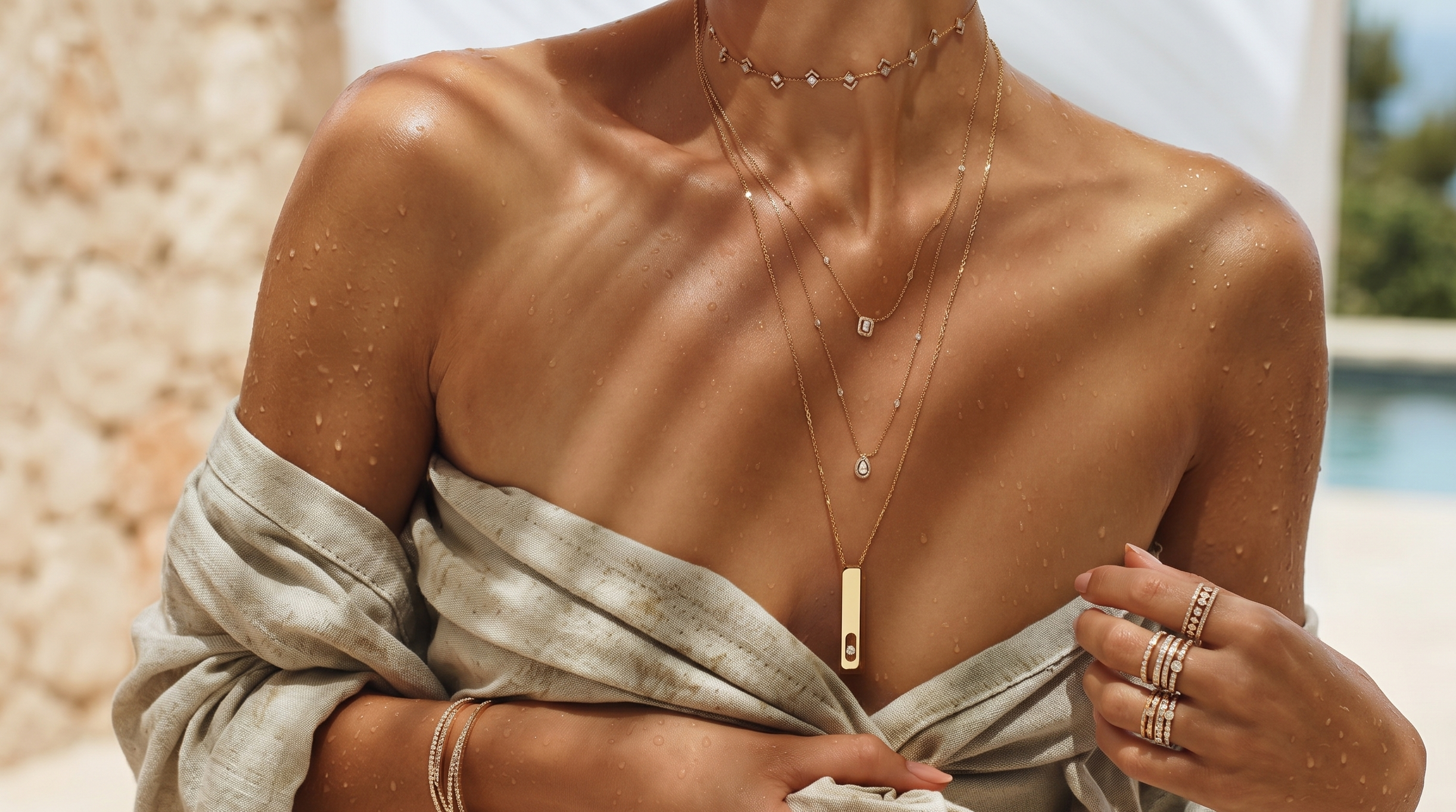 Woman wearing gold jewelry outdoors with a scenic background