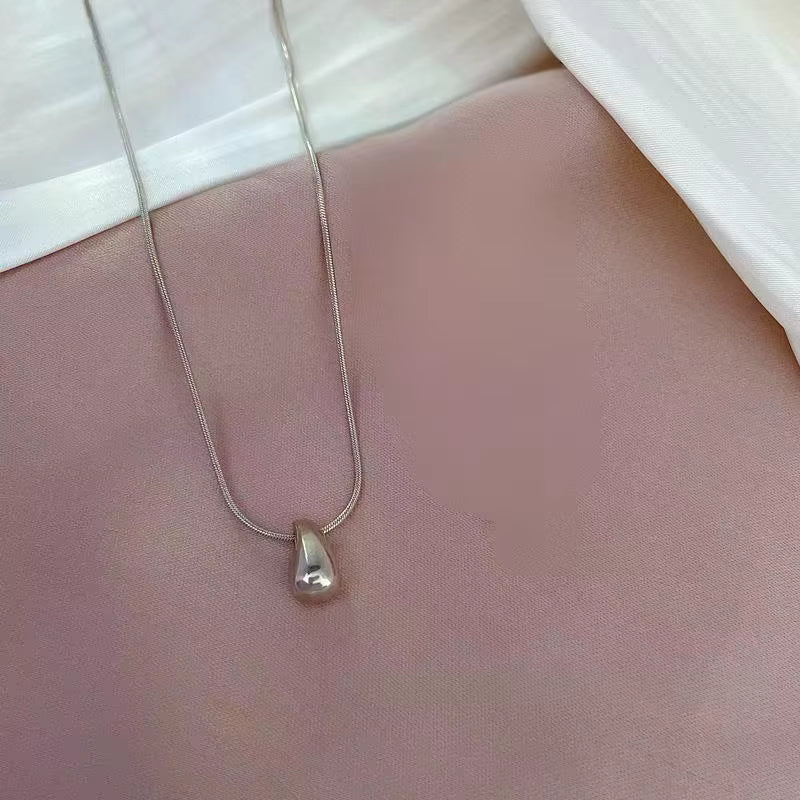 Larme Pendant Necklace — sculptural silver pendant lifestyle | THE ARCIVE