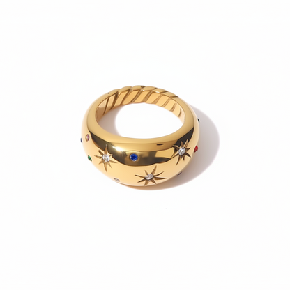 Gold ring with star designs on a white background