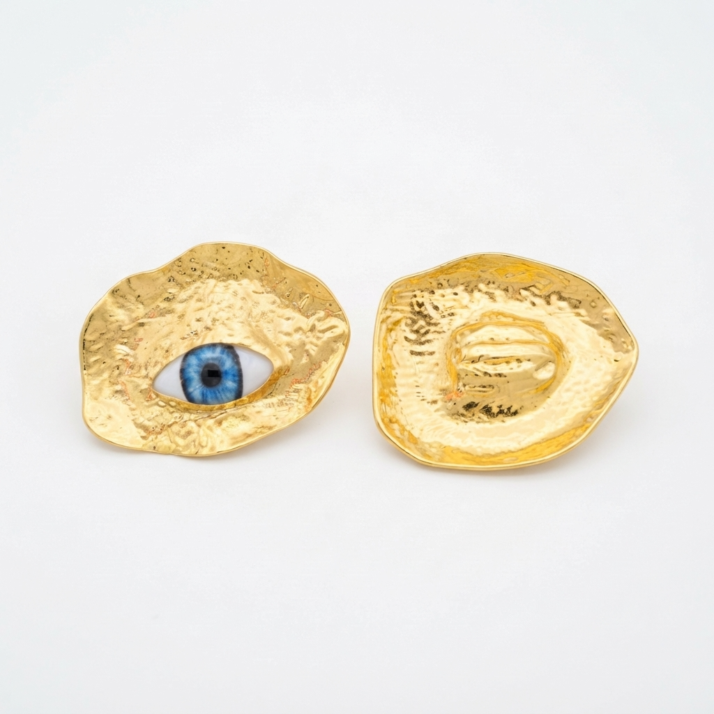 The Horus Studs, hammered gold-tone discs with blue eye, product view | THE ARCIVE