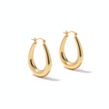 The Swan Hoops, elongated gold oval hoop earrings, angled view | THE ARCIVE