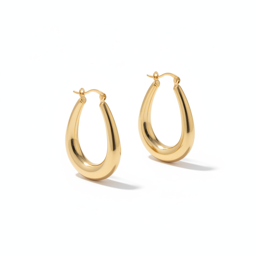 The Swan Hoops, elongated gold oval hoop earrings, angled view | THE ARCIVE