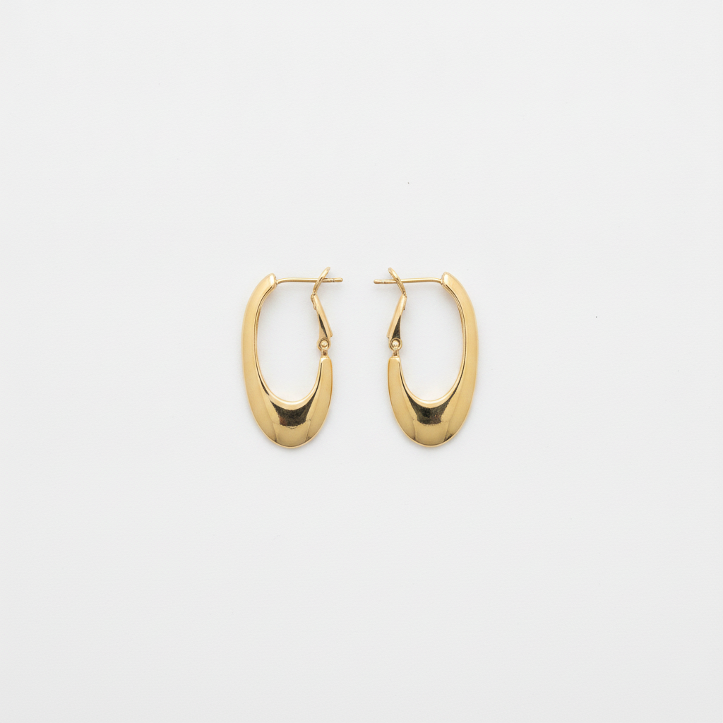 The Teardrop Hoops, gold-tone oval hoop earrings, flat lay view | THE ARCIVE