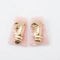 The Visage Studs, gold face and pink marble statement earrings, product view | THE ARCIVE
