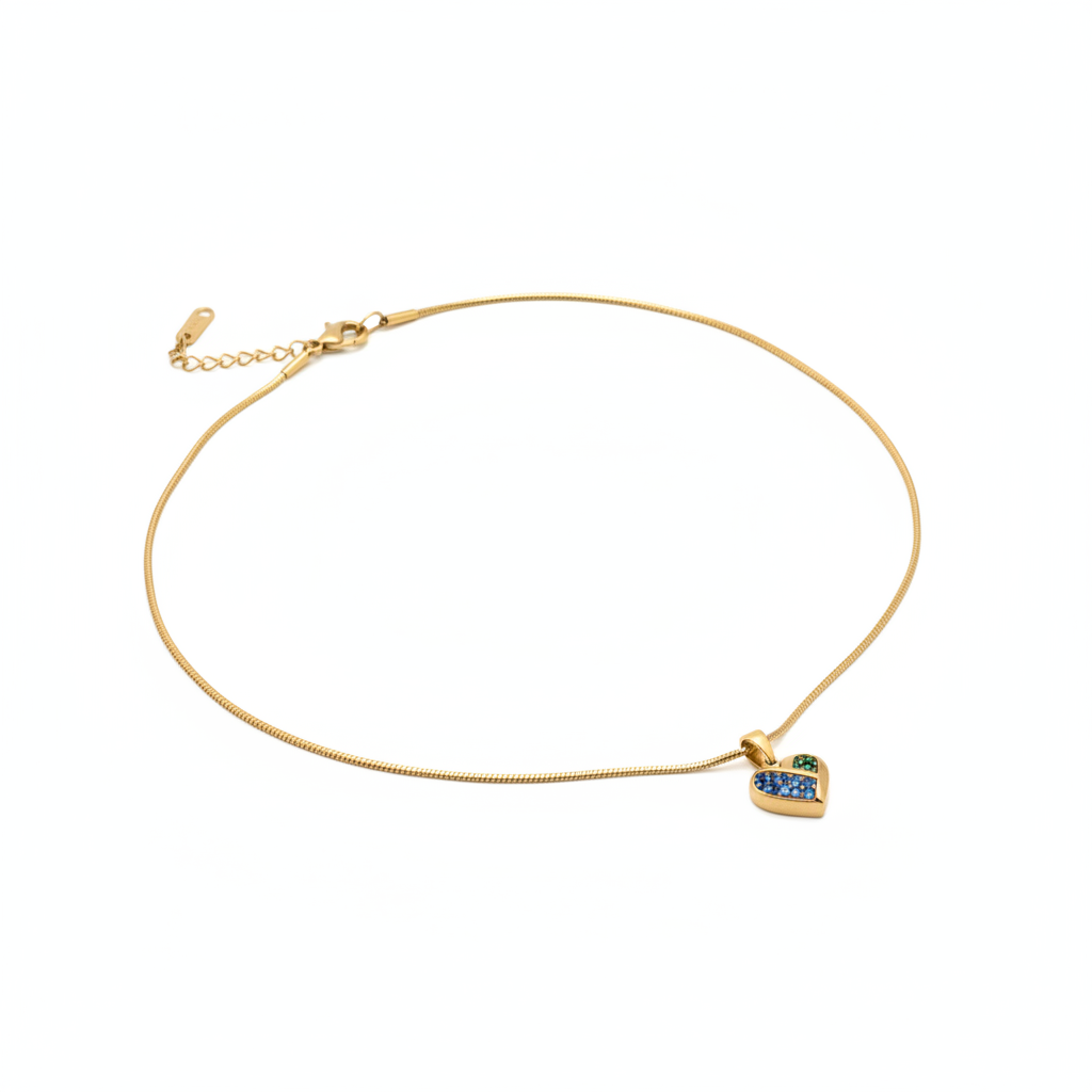 Trésor Pendant - heart pendant with blue baguette crystal on snake chain angled view | THE ARCIVE